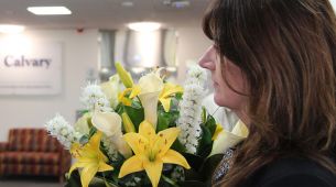 Visitor bringing flowers to patient at hospital