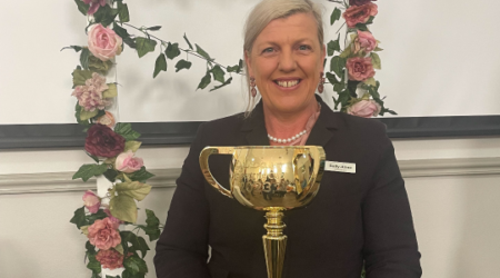 Female staff member at Calvary St Joseph's aged care home holding the melbourne cup