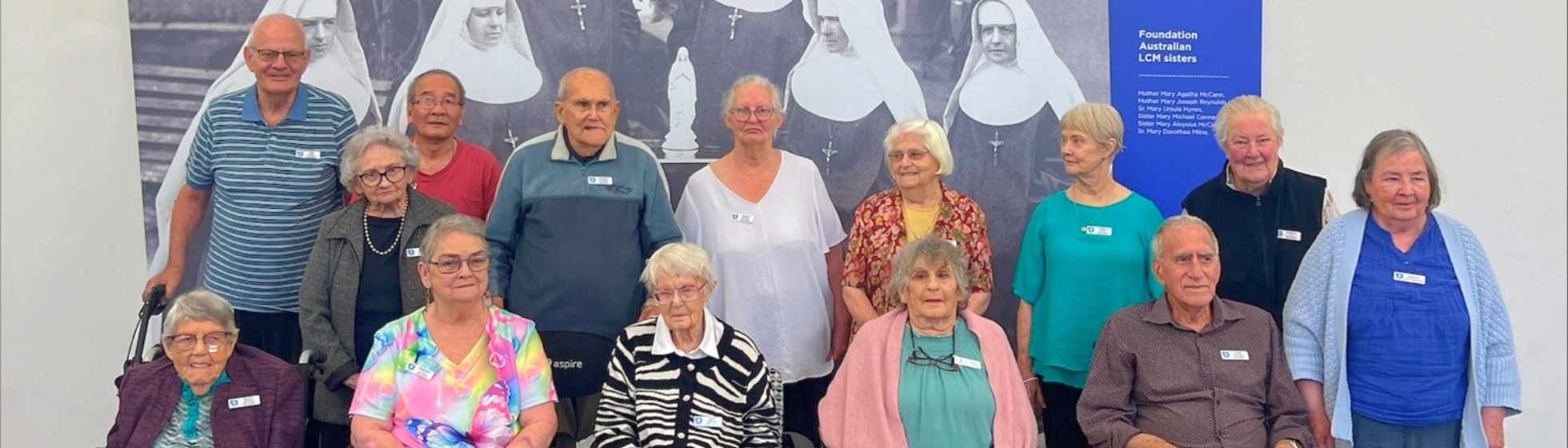 a group of elderly aged care residents posing for a photo