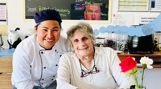 an elderly resident and chef smiling for a photo