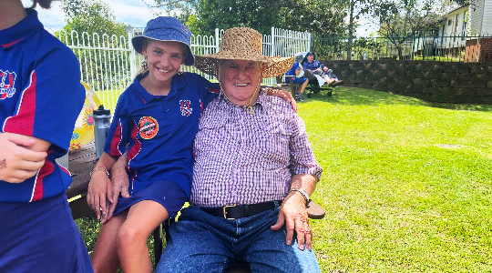 a child and elderly man smiling for a photo